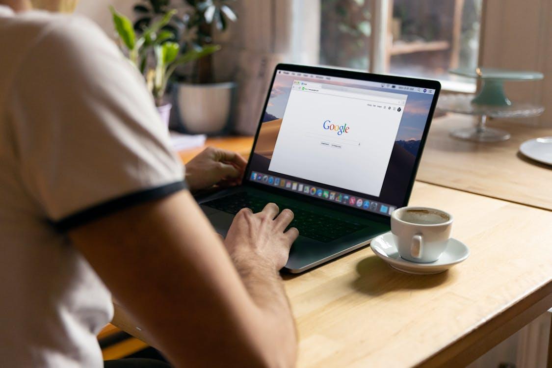 A person uses Google on their laptop.